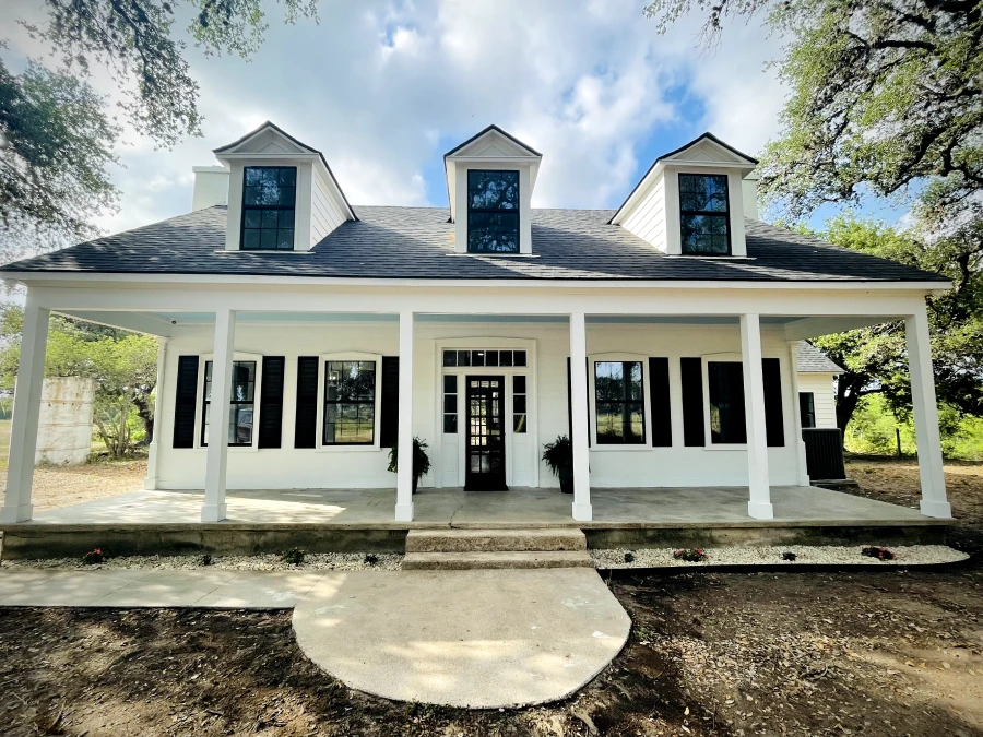 Two-story house with large porch.